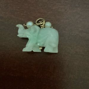 Gorgeous and unique authentic Jade Elephant adorned with two seed pearls.